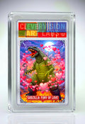 Trading card featuring Godzilla with hearts, encased in a protective frame.