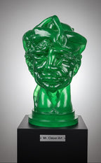 Green glass sculpture of a face on a black pedestal with 'Mr. Clever Art' label.