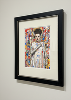 Framed artwork of a colorful portrait on a white wall