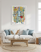 Framed artwork of a tin man in a living room with a sofa and coffee table.