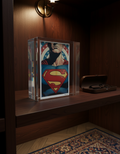Superman logo in a clear glass block on a wooden shelf