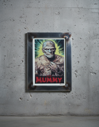 Framed poster of 'The Mummy' character on a gray wall.