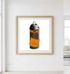 Framed artwork of a spray can with an orange label on a white wall.