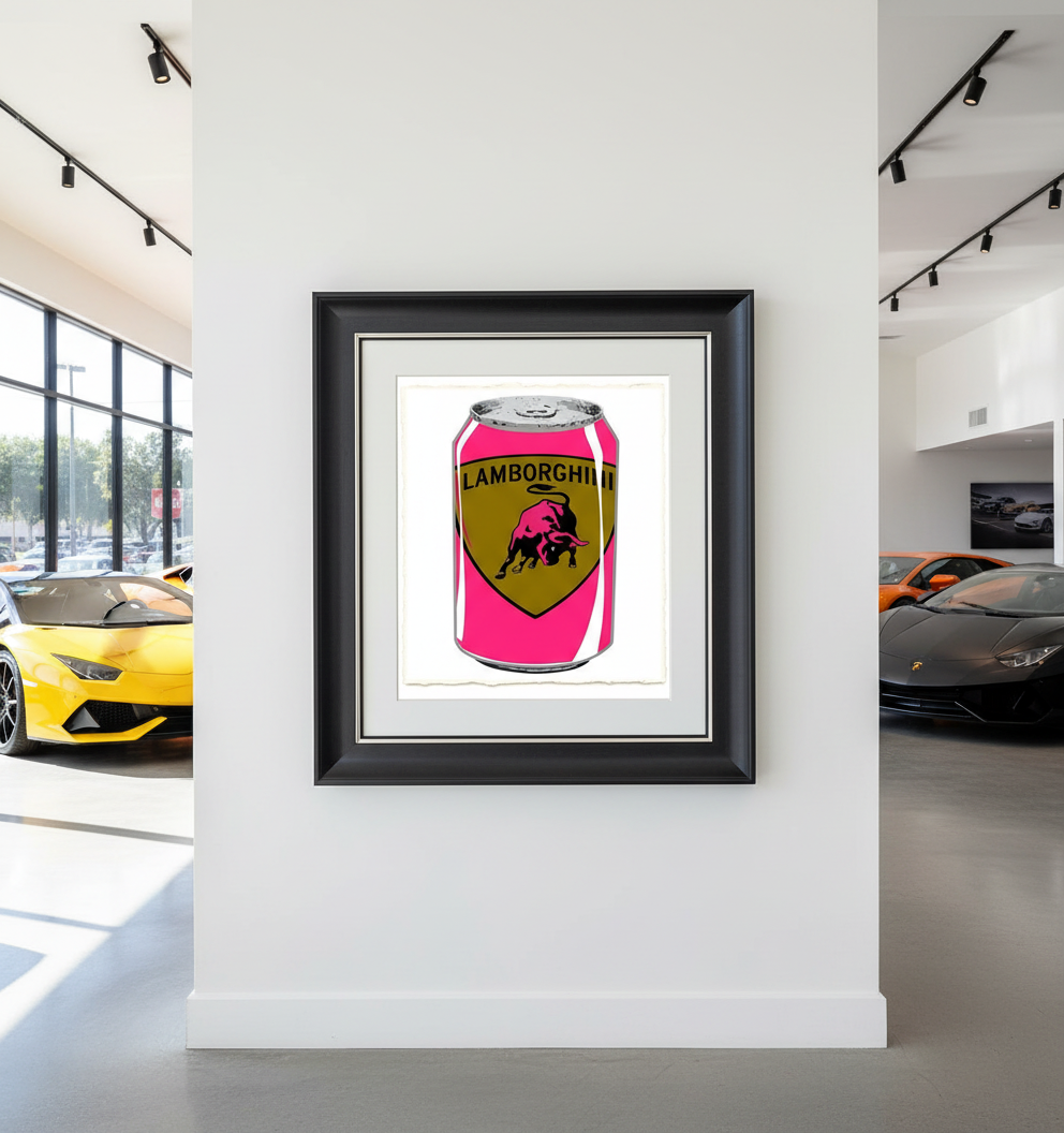 Framed artwork of a pink can with Lamborghini logo in a car showroom.