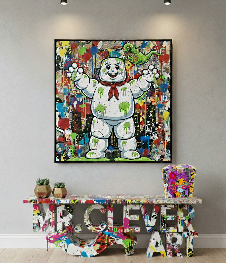 Colorful abstract painting of a character on a wall above a similarly decorated table.