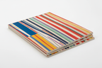 Stack of modern abstract art prints with vertical color stripes