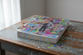 Stack of Charlie Chaplin holographic prints on vintage wood table