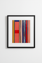 Framed abstract art print with vertical stripes and color blocks in modern black frame