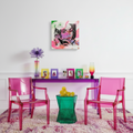 Modern interior with pink chairs, a purple table, and colorful decor.