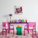 Modern interior with pink chairs, a purple table, and colorful decor.